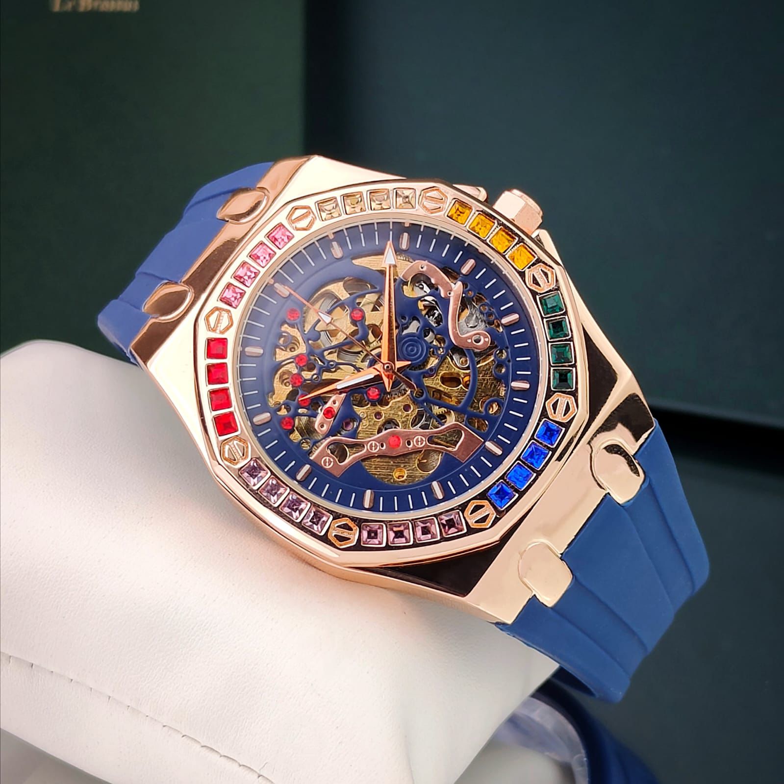 AUDEMAR_S PIGUET AUTOMATIC MECHANICAL WATCH WITH A SKELETON DIAL A ROSE GOLD TONE ALLOY CASH AND A BLUE SILICONE STRAP