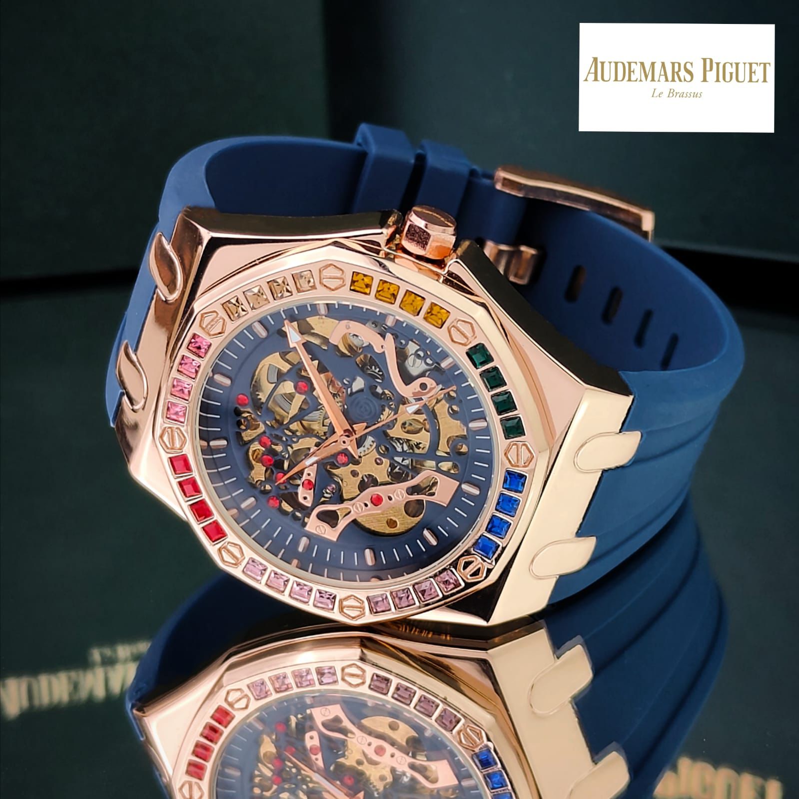 AUDEMAR_S PIGUET AUTOMATIC MECHANICAL WATCH WITH A SKELETON DIAL A ROSE GOLD TONE ALLOY CASH AND A BLUE SILICONE STRAP